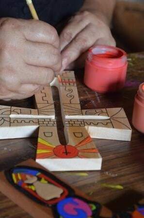 Another close-up of Lita painting the cross