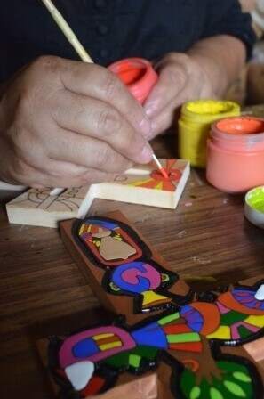 A close-up of Lita painting the cross